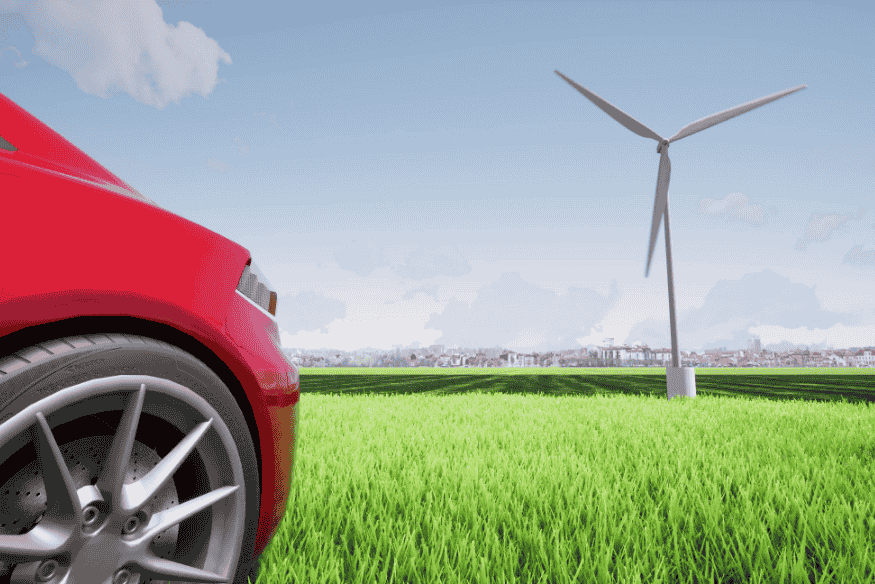 Parte frontal de um carro vermelho ao lado de uma turbina eólica em um campo verde